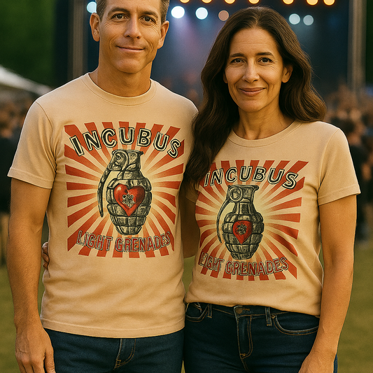 Two people wearing Incubus t-shirts at an outdoor event with stage lights in the background.